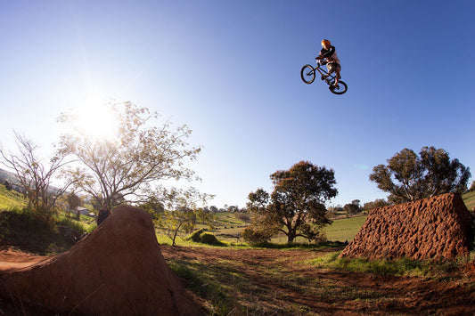 Jonny Mackellar blasting a 360 table over dirt jumps